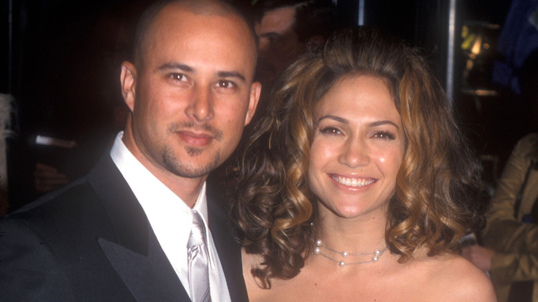 Jennifer Lopez and Chris Judd smiling for cameras