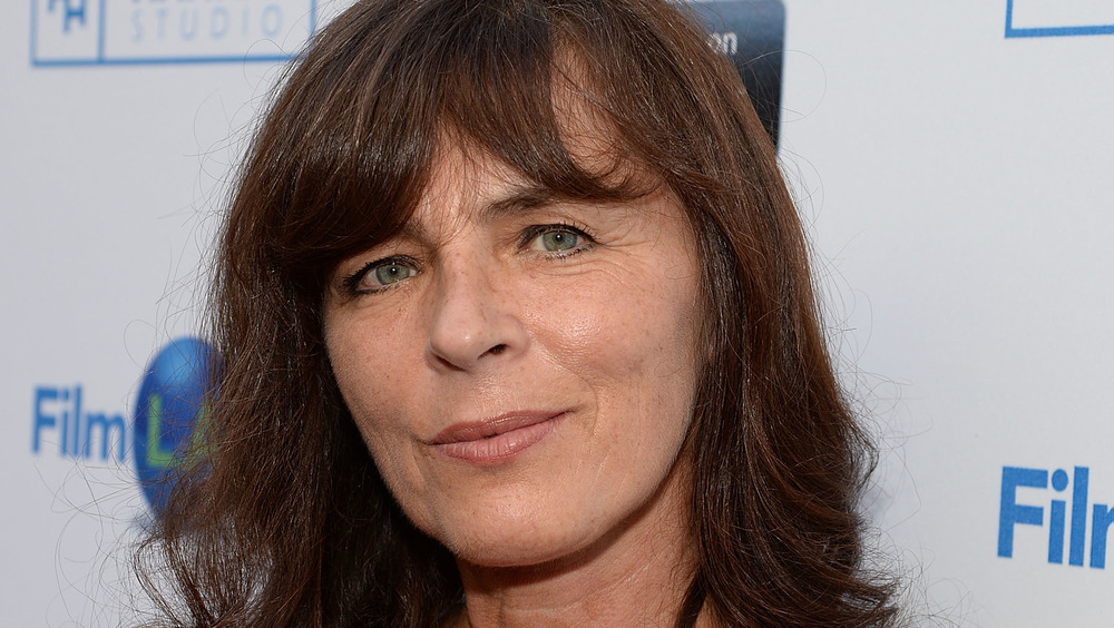 Mira Furlan smiling with her lips closed