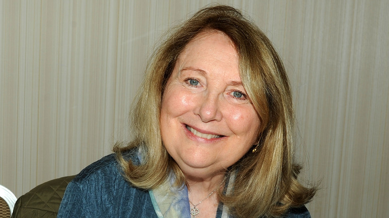 Teri Garr smiling wearing a blue jacket