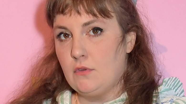Lena Dunham posing with pink background