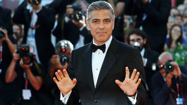 George Clooney posing on red carpet