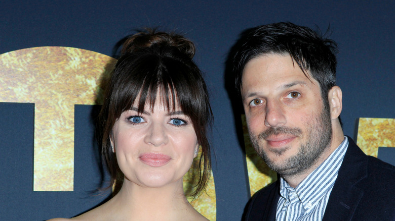 Casey Wilson and David Caspe posing at an event