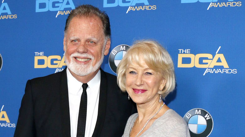 Taylor Hackford and Helen Mirren smiling on a red carpet