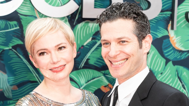 Michelle Williams and Thomas Kail posing on a red carpet