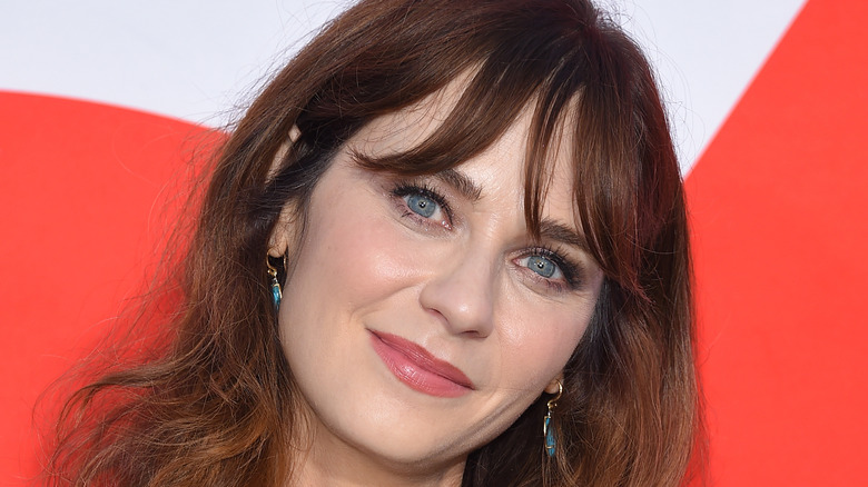 Zooey Deschanel smiling at an event 