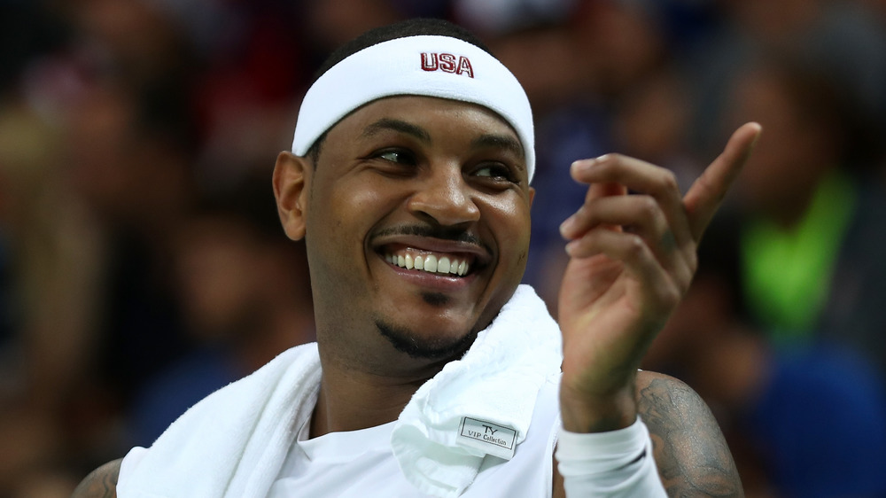 Carmelo Anthony smiling and pointing off-camera