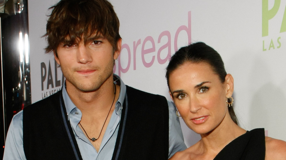 Ashton Kutcher and Demi Moore looking at camera