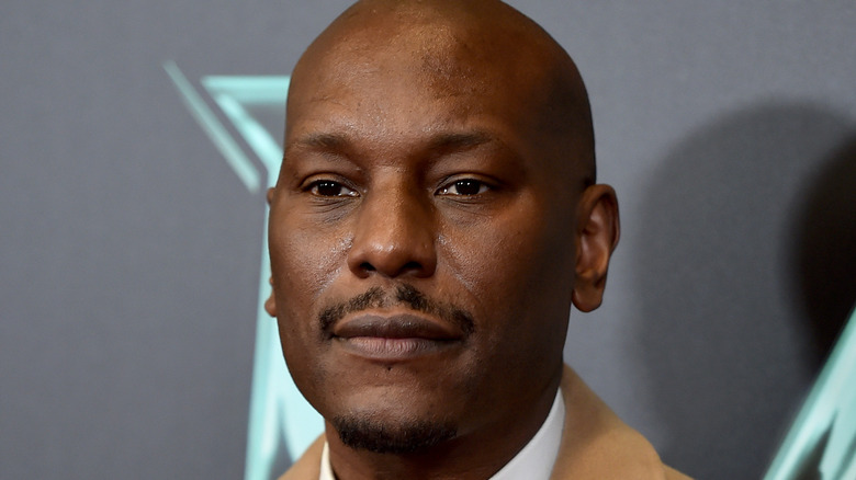 Tyrese wearing a brown jacket