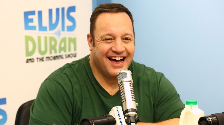 Kevin James sitting in front of a microphone