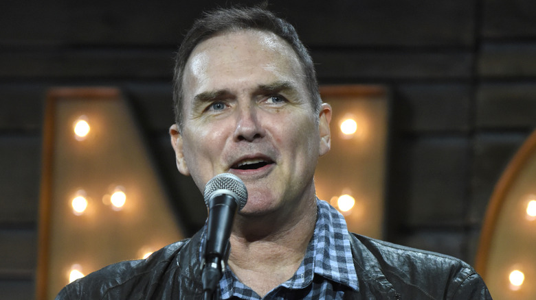  Norm Macdonald holding a microphone