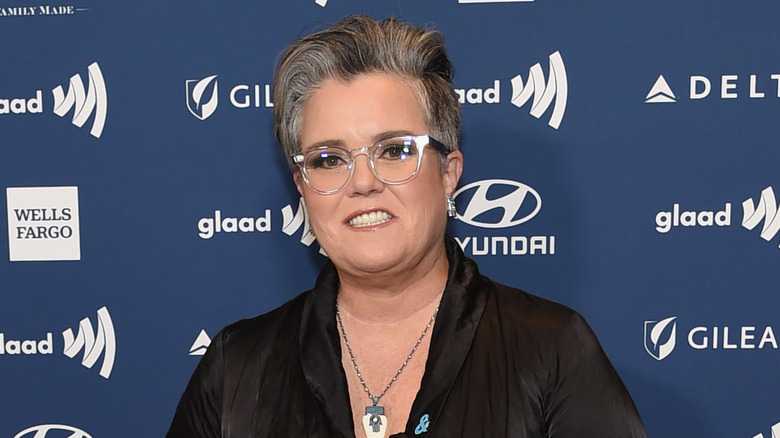 Rosie O'Donnell in front of a blue wall