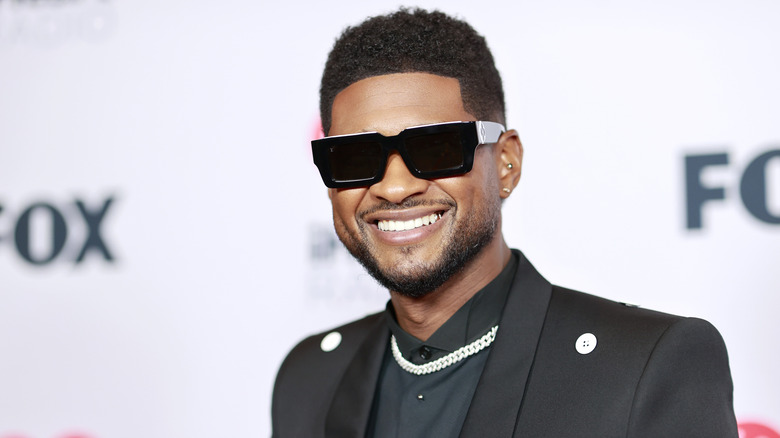 Usher wearing dark glasses