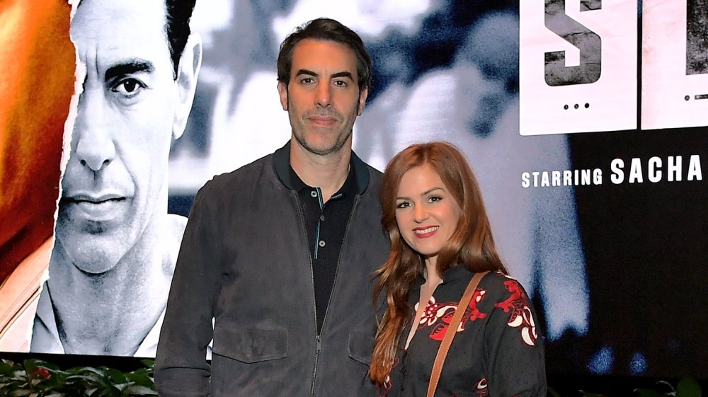 Sacha Baron Cohen with arm around Isla Fisher