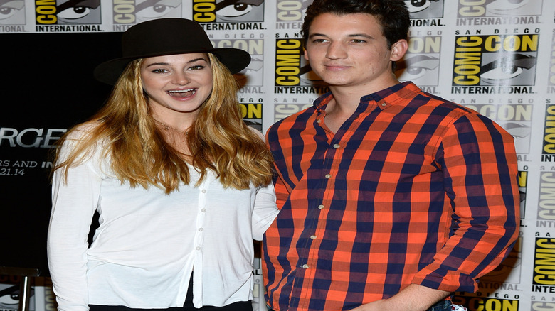 Shailene Woodley with mouth open beside Miles Teller at Comic-Con International 2013