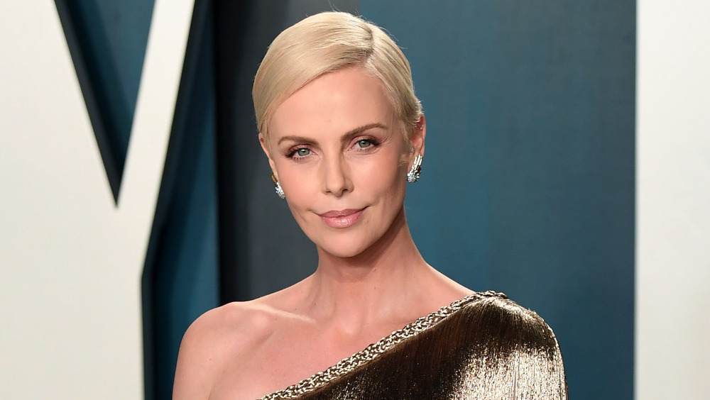 Charlize Theron smirking