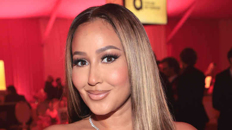 Adrienne Bailon smiling at event