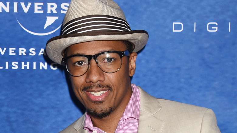 Nick Cannon smiling wearing trilby