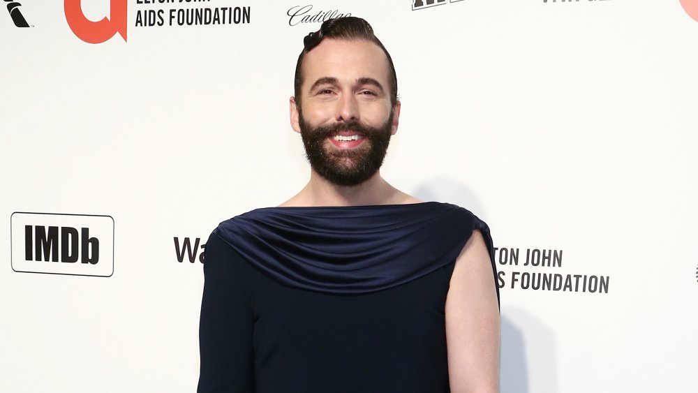 Jonathan Van Ness in a long gown posing on the red carpet 