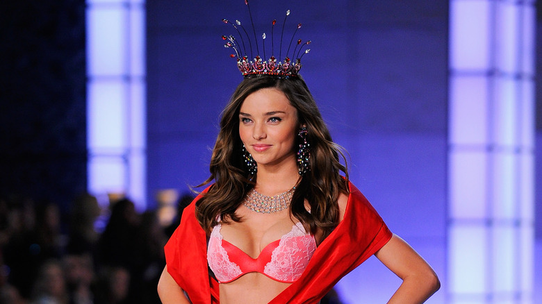 Miranda Kerr walking down the runway with a crown on