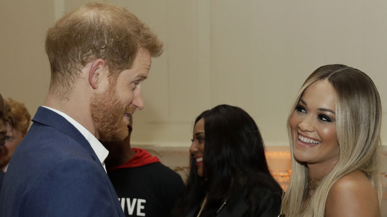 Rita Ora smiling at Prince Harry