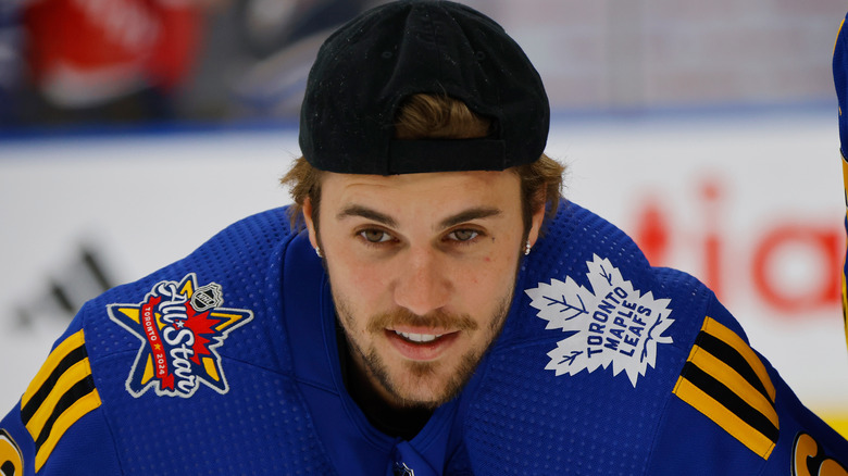 Justin Bieber smiling playing hockey