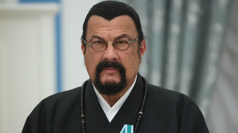 Steven Seagal grimacing in glasses