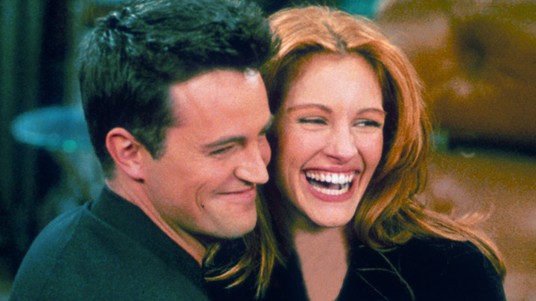 Matthew Perry and Julia Roberts smiling and embracing