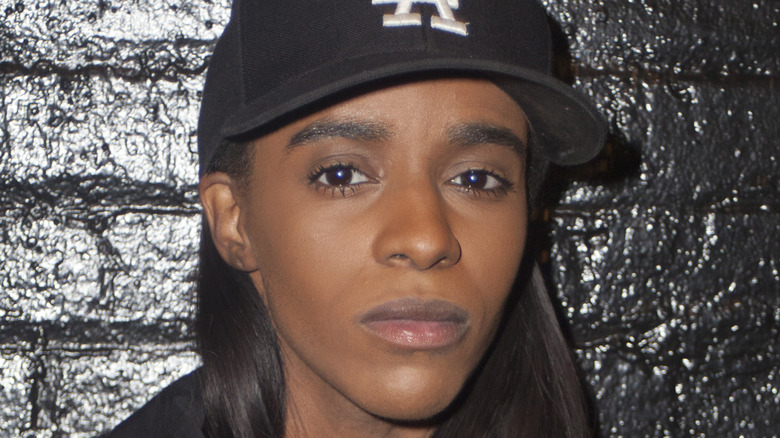 Angel Haze posing backstage in hat