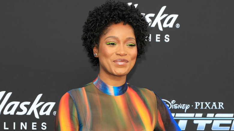 Keke Palmer wearing a curled afro with a multicolored collared dress