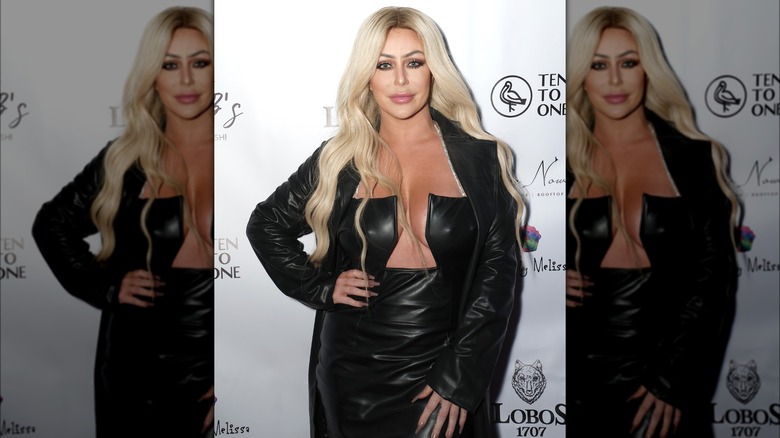 Aubrey O'Day posing in an all-black outfit at Josh McBride's birthday celebration