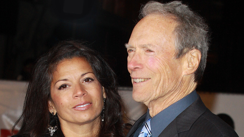 Dina Eastwood and Clint Eastwood posing together