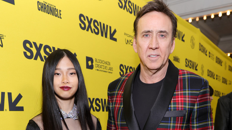 Riko Shibata and Nicolas Cage smiling on red carpet