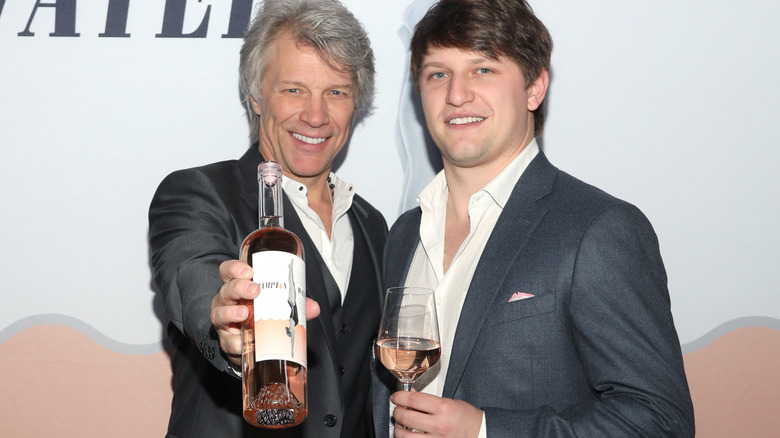 Jon Bon Jovi and Jesse Bongiovi smiling with wine