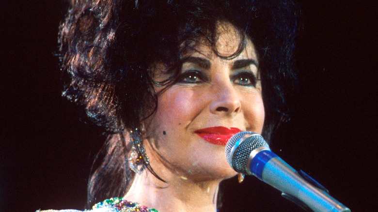 Elizabeth Taylor in front of a microphone