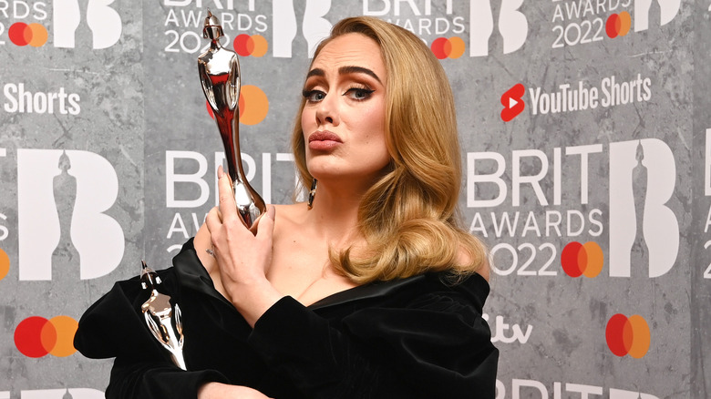 Adele holding Brit Awards