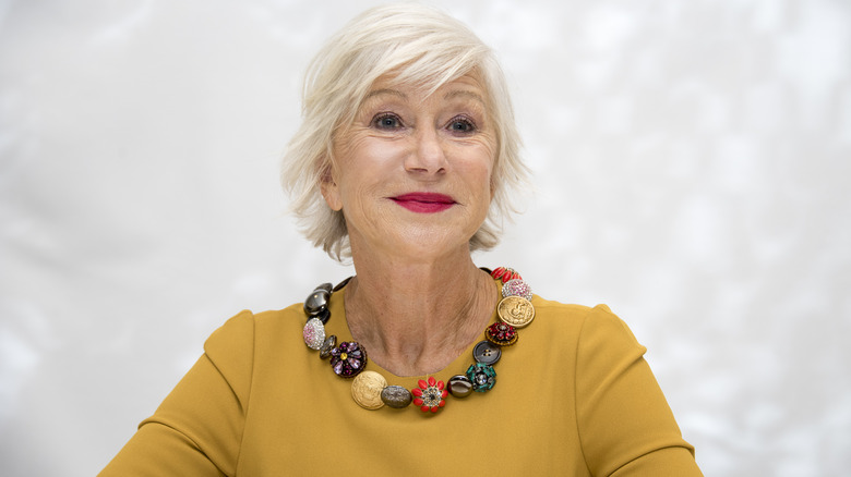 Helen Mirren smiling in yellow shirt