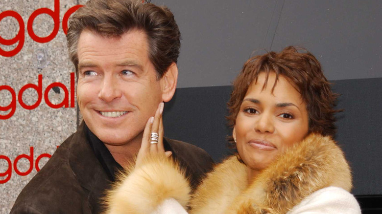 Halle Berry with hand on Pierce Brosnan's face