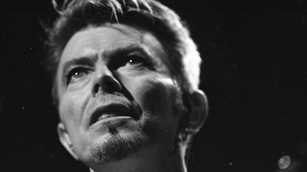 Black-and-white photo of David Bowie looking up