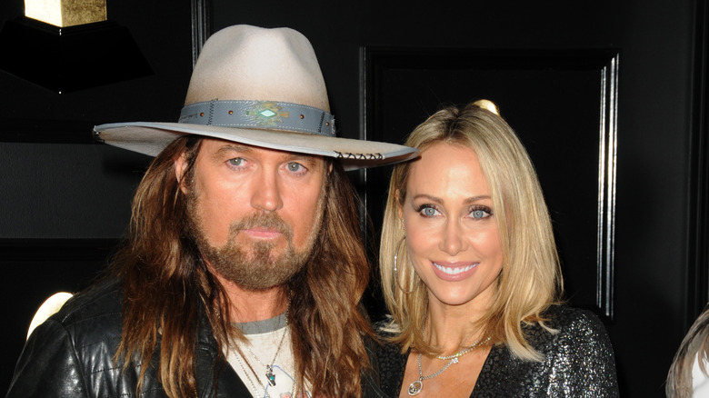 Billy Ray Cyrus and Trish Cyrus posing at an event