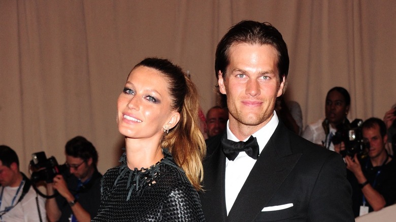 Tom Brady and Gisele Bundchen posing on a red carpet