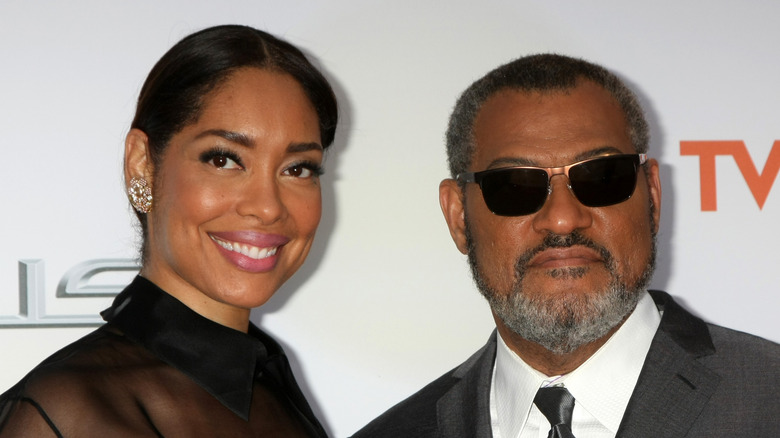 Gina Torres and Laurence Fishburne posing at an event