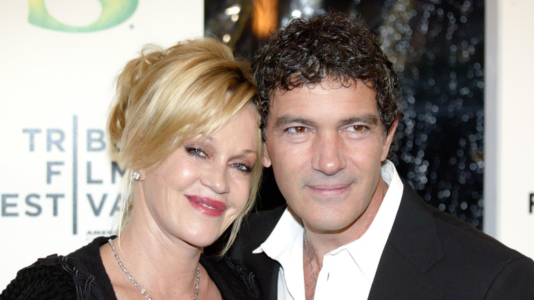 Antonio Banderas and Melanie Griffith posing at an event