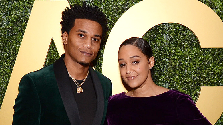 Tia Mowry and Cory Hardrict posing at an event