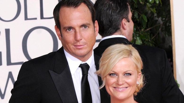 Amy Poehler and Will Arnett posing on a red carpet