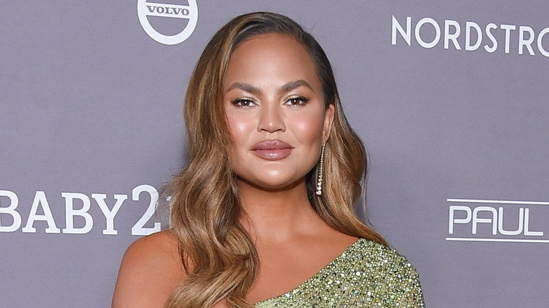 Chrissy Teigen in a green gown