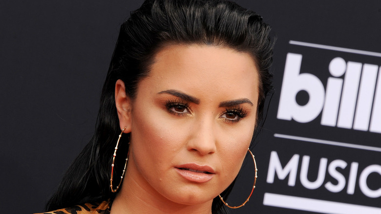 Demi Lovato sporting hoop earrings