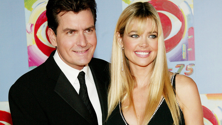 Charlie Sheen smiling with Denise Richards
