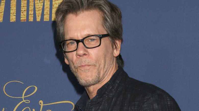 Kevin Bacon posing in glasses