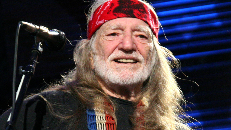 Willie Nelson performing onstage 