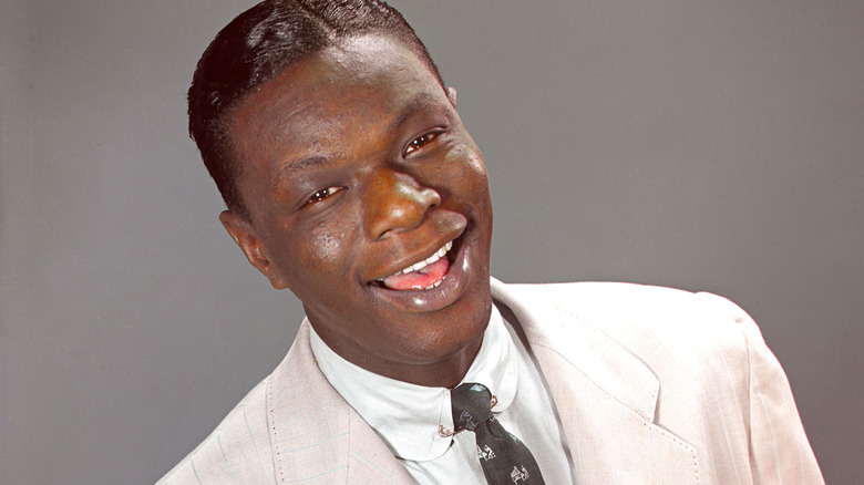 Nat King Cole smiling while performing